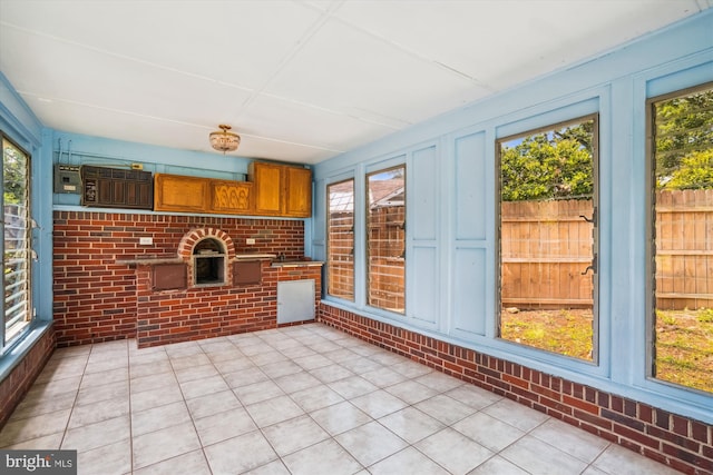5506 39th Ave, Hyattsville, MD 20781 - unfurnished sunroom with brick wall, plenty of natural light, and tile patterned flooring
