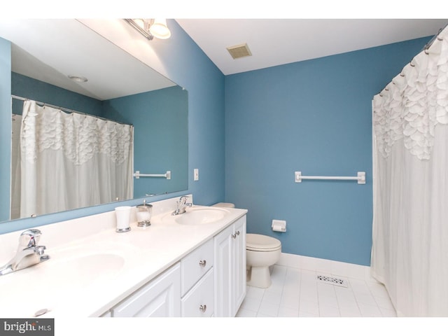 bathroom featuring a sink, baseboards, tile patterned flooring, and visible vents