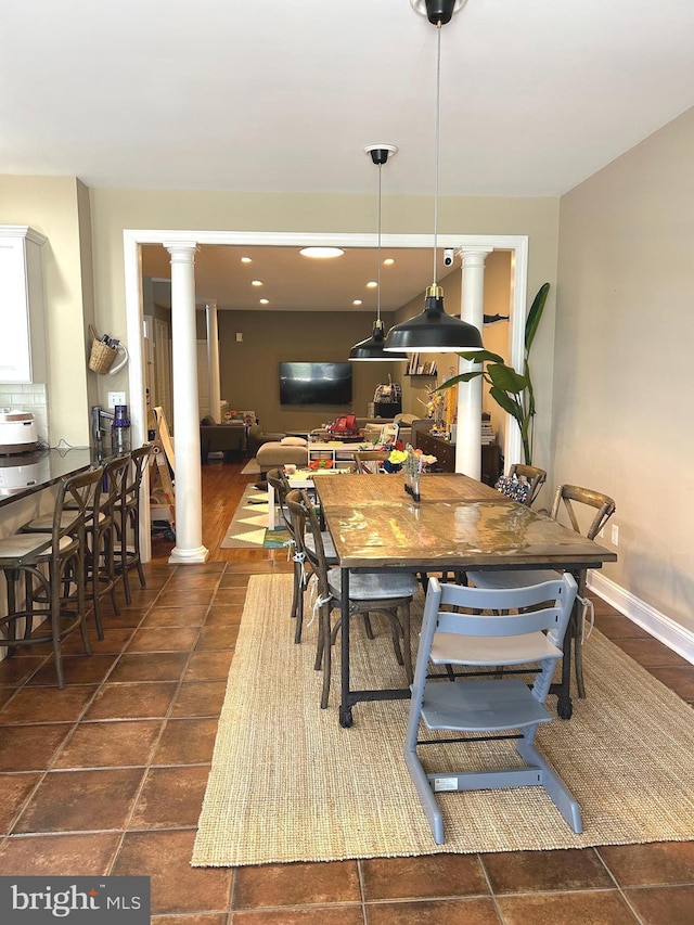 tiled dining area featuring ornate columns