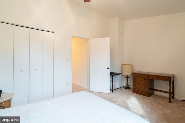 bedroom featuring a closet, baseboards, and carpet floors