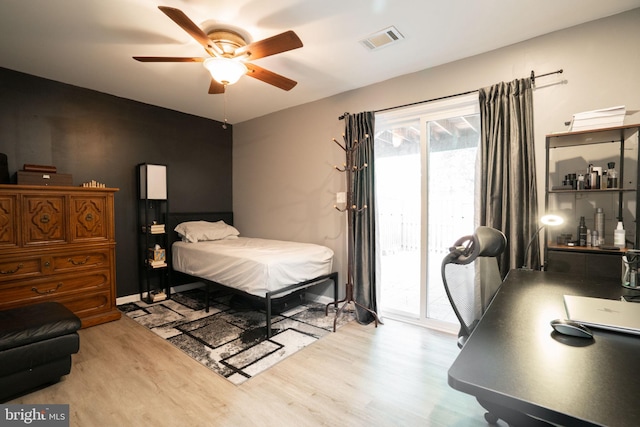 bedroom with ceiling fan, access to outside, visible vents, and wood finished floors