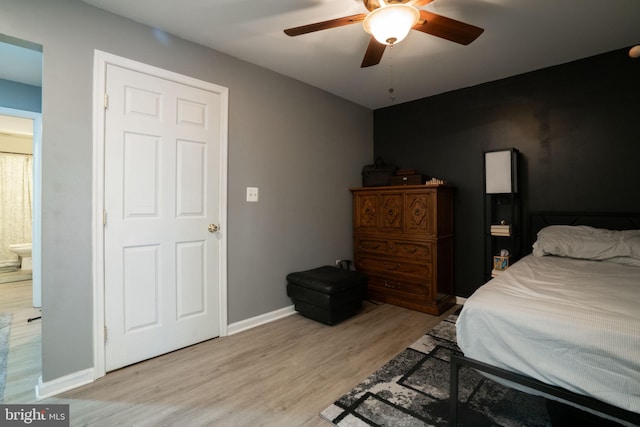 bedroom featuring baseboards, light wood-style flooring, and a ceiling fan