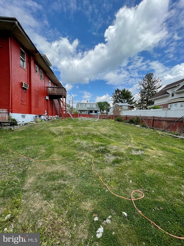 view of yard featuring stairway, fence, and a wooden deck