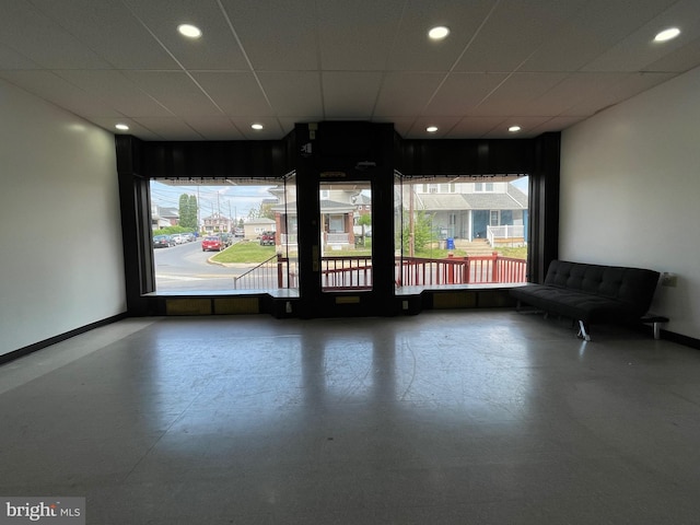 interior space with concrete floors, a wealth of natural light, baseboards, and recessed lighting