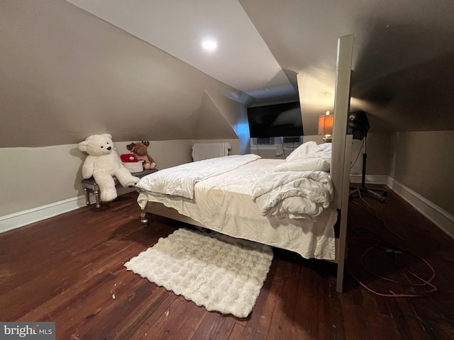 bedroom featuring vaulted ceiling, wood-type flooring, and baseboards