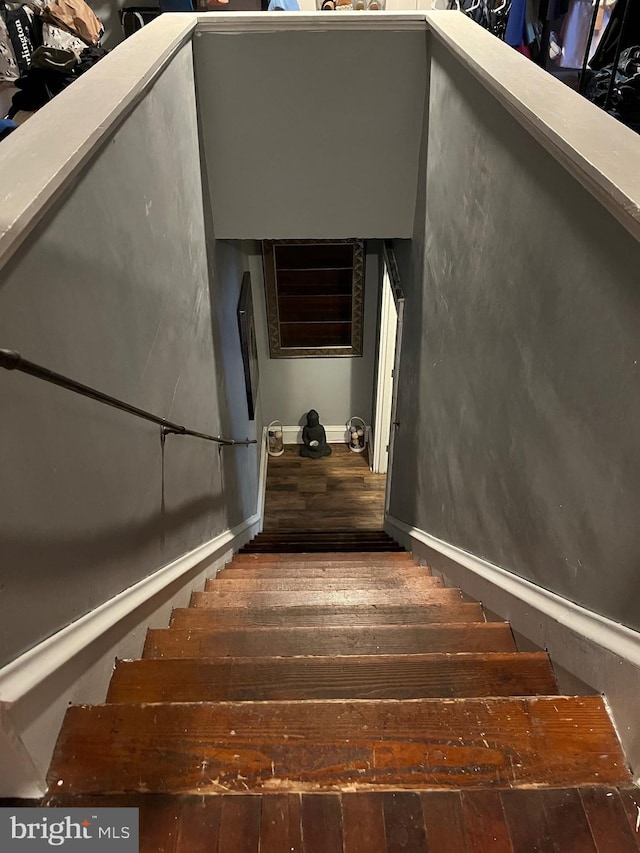 stairs featuring hardwood / wood-style floors