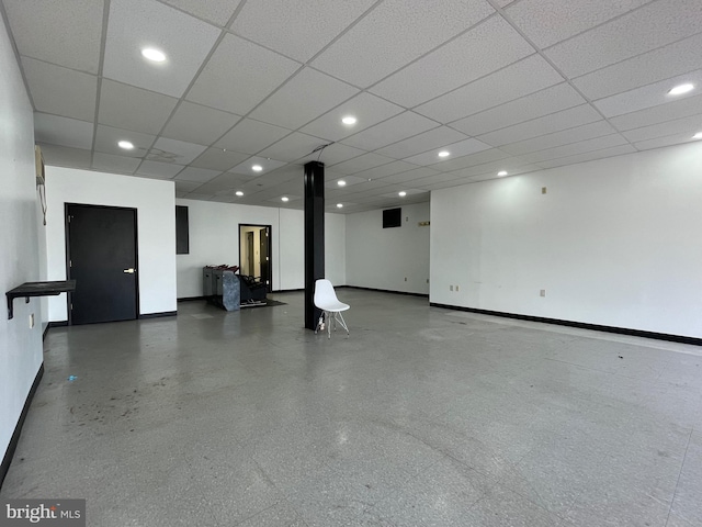 interior space with a paneled ceiling, baseboards, and recessed lighting