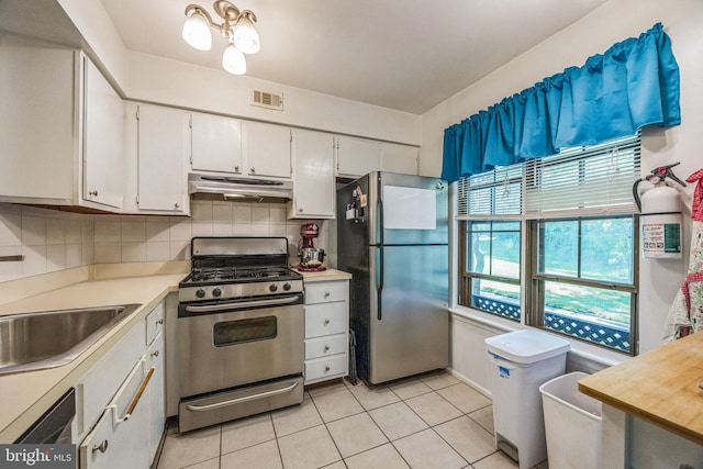 165 Bradford Ct, Mount Laurel, NJ 08054 - kitchen featuring stainless steel appliances, under cabinet range hood, light tile patterned flooring, light countertops, and white cabinets