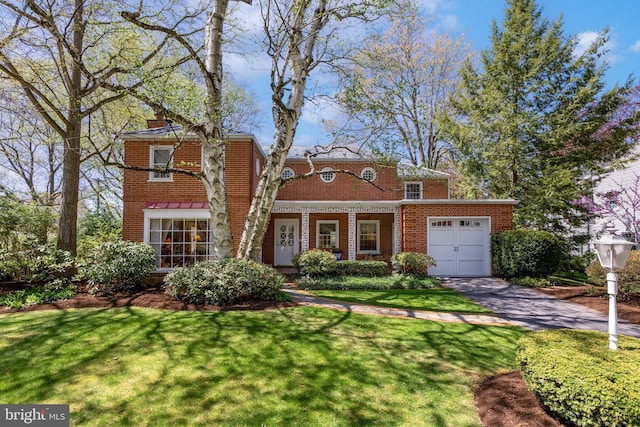 465 Hillcrest Ave, State College, PA 16803 - view of front of home with a garage, aphalt driveway, a front yard, a chimney, and brick siding