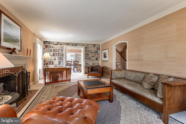 465 Hillcrest Ave, State College, PA 16803 - living room featuring crown molding, built in features, stairs, a fireplace, and arched walkways