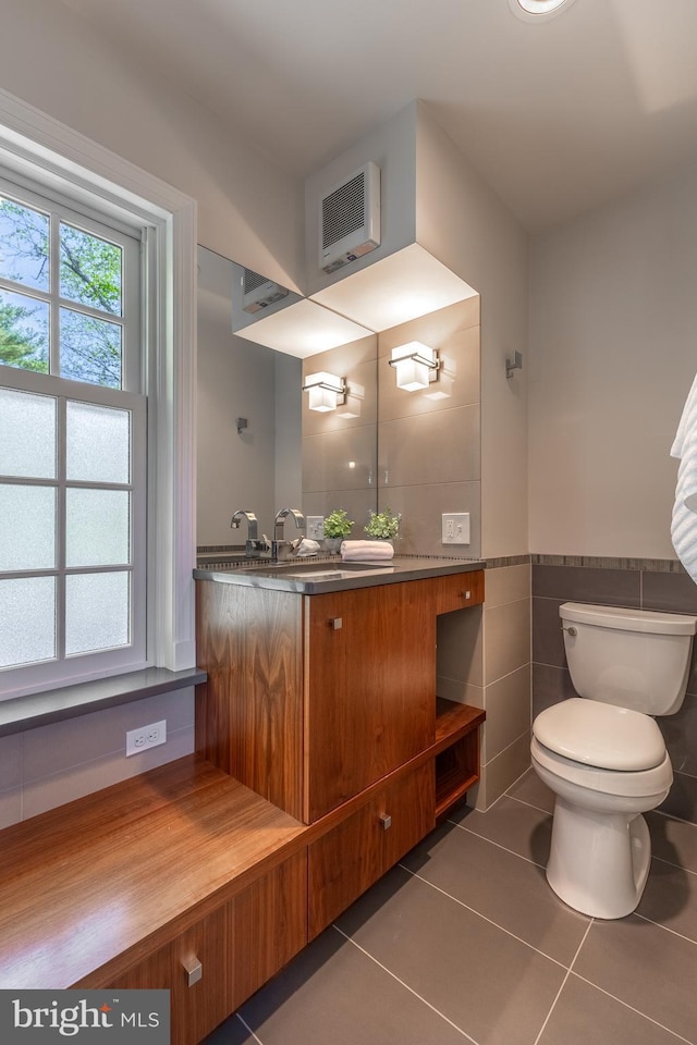 465 Hillcrest Ave, State College, PA 16803 - half bathroom with tile patterned flooring, vanity, wainscoting, toilet, and tile walls