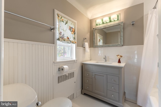 465 Hillcrest Ave, State College, PA 16803 - full bathroom with vanity, wainscoting, toilet, radiator heating unit, and tile patterned floors