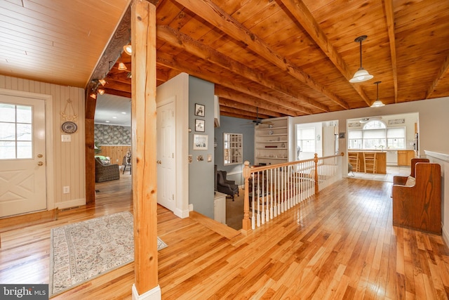 entryway featuring plenty of natural light, beam ceiling, and light wood-type flooring