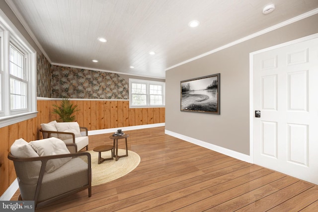 sitting room with wainscoting, recessed lighting, baseboards, wood finished floors, and ornamental molding