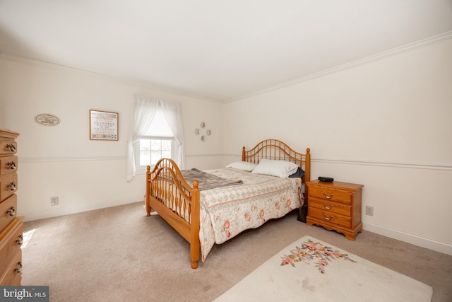 bedroom with crown molding, baseboards, and carpet