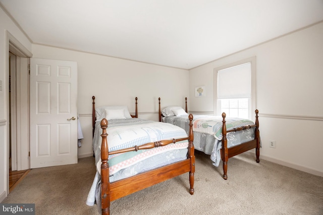 bedroom with baseboards and light colored carpet