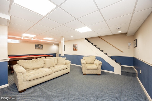carpeted living room with baseboards, stairs, pool table, and a paneled ceiling
