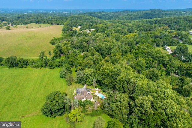 drone / aerial view with a wooded view