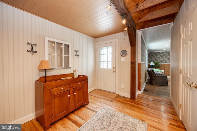 entrance foyer featuring baseboards, wood ceiling, and light wood-style flooring