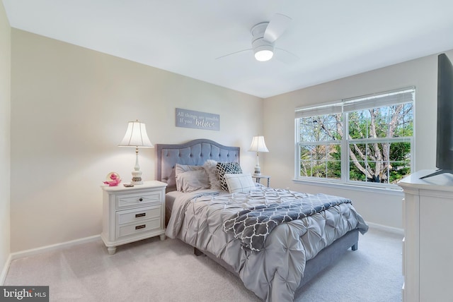 bedroom with baseboards, ceiling fan, and light colored carpet