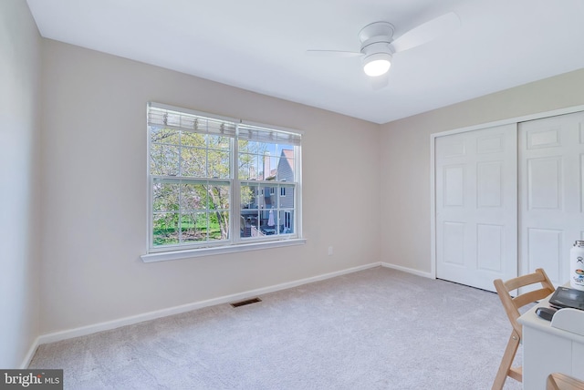 unfurnished office with carpet floors, baseboards, and visible vents