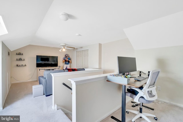 office area featuring ceiling fan, vaulted ceiling, and light carpet