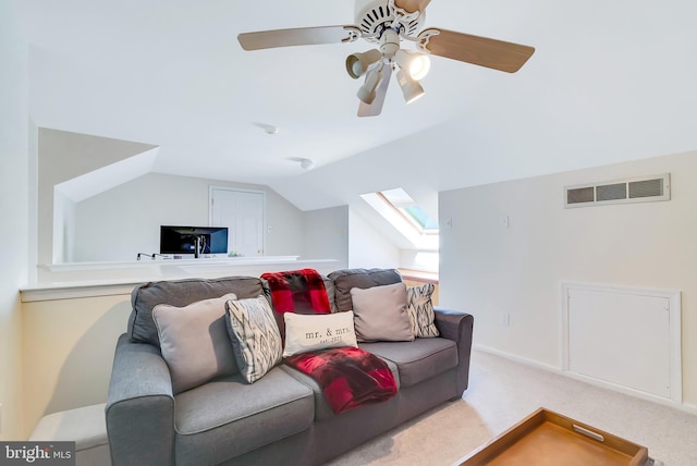 carpeted living area featuring vaulted ceiling with skylight and visible vents