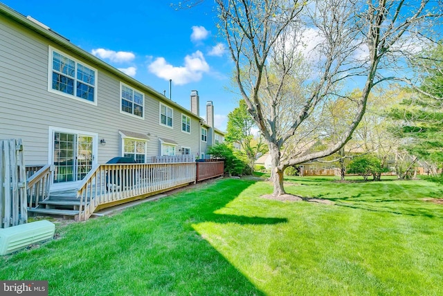 view of yard featuring a wooden deck