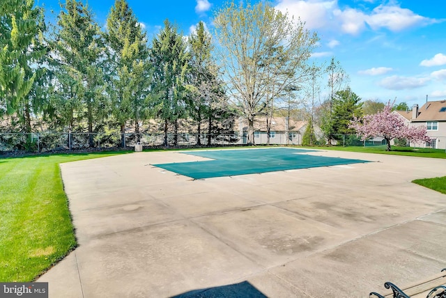 view of pool featuring fence and a yard