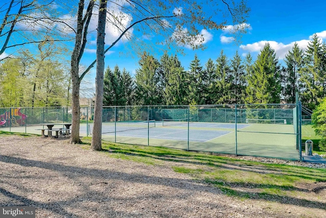 view of tennis court with fence