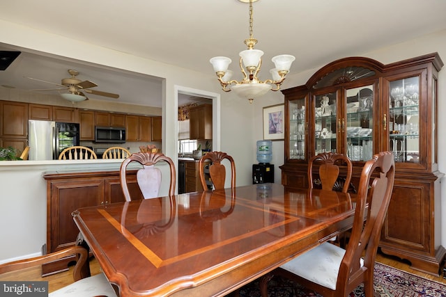 dining room with ceiling fan with notable chandelier