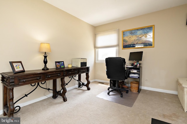 carpeted home office featuring baseboards