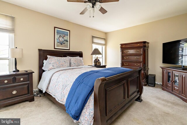 bedroom featuring ceiling fan and light colored carpet