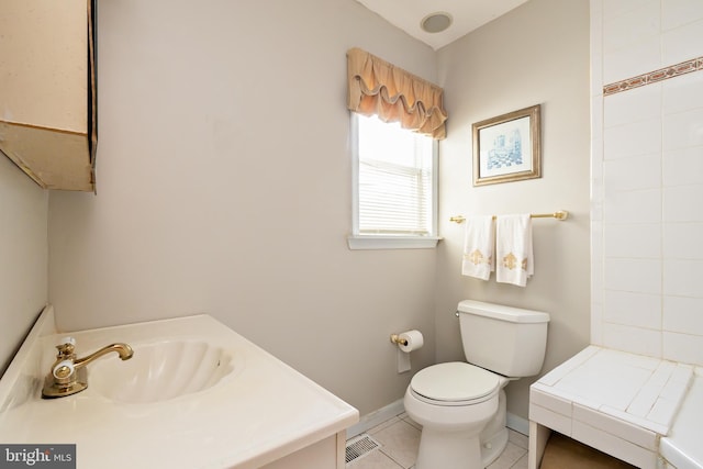 full bath with a sink, tile patterned flooring, toilet, baseboards, and visible vents