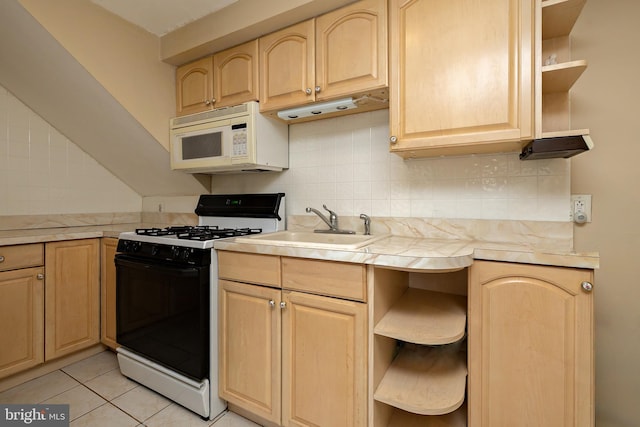 kitchen with light brown cabinets, open shelves, black gas range oven, and white microwave
