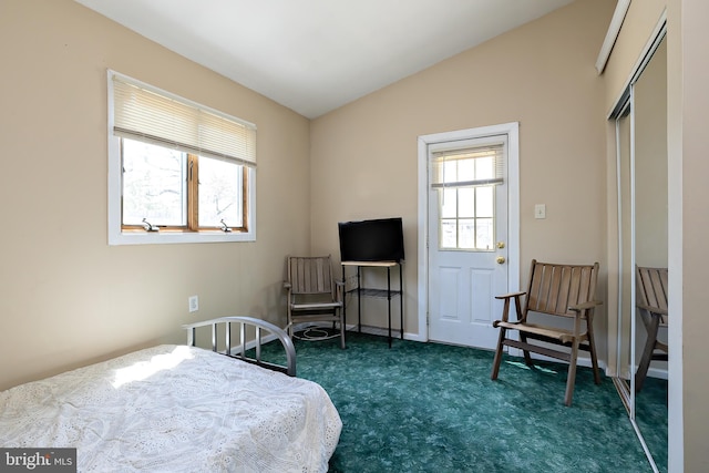 carpeted bedroom with lofted ceiling