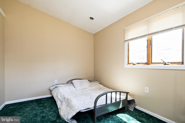 bedroom featuring baseboards and carpet flooring