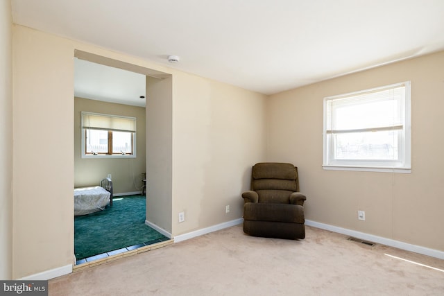 sitting room featuring baseboards, carpet, and visible vents