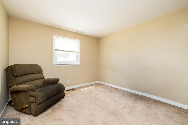 sitting room featuring visible vents, baseboards, and carpet floors
