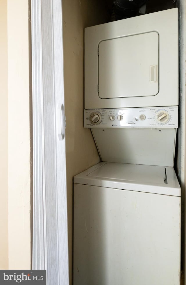 laundry room featuring laundry area and stacked washer / drying machine