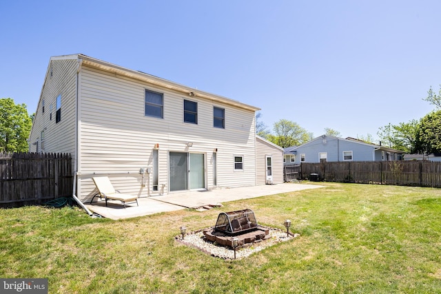 back of property featuring a fenced backyard, an outdoor fire pit, a patio area, and a yard