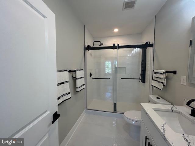full bathroom with visible vents, vanity, toilet, and a shower stall