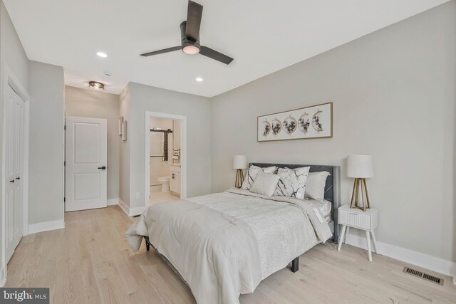 bedroom with visible vents, baseboards, recessed lighting, light wood finished floors, and ensuite bath