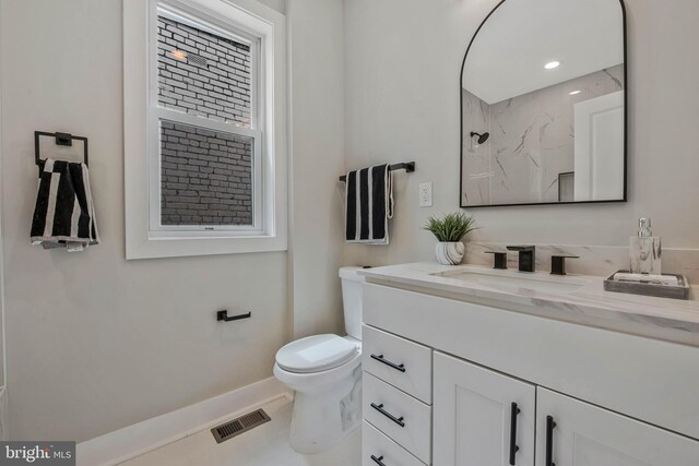 bathroom featuring visible vents, vanity, a shower, toilet, and baseboards