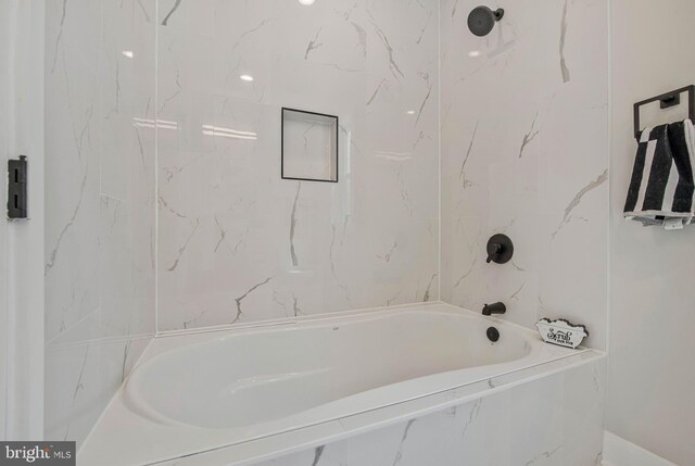 bathroom featuring a combined bath / shower with marble appearance