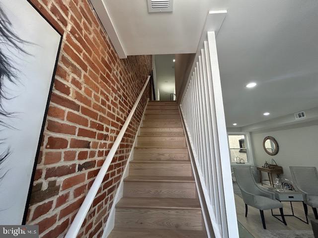 stairway with brick wall and visible vents