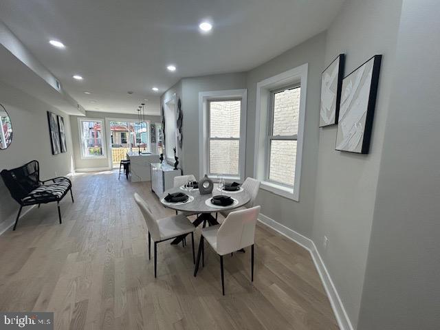 dining area featuring baseboards, recessed lighting, and light wood-style flooring