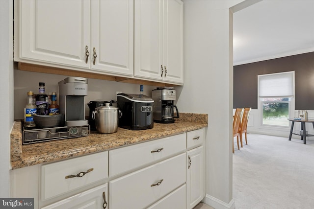 1 Arbor Lea Cir, Doylestown, PA 18901 - kitchen featuring light carpet, white cabinetry, light stone counters, ornamental molding, and baseboards