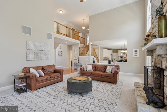 1 Arbor Lea Cir, Doylestown, PA 18901 - living area with a towering ceiling, stairway, baseboards, a chandelier, and a fireplace