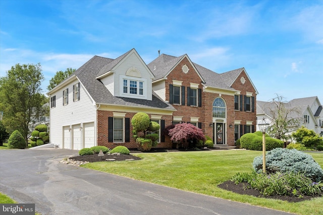 1 Arbor Lea Cir, Doylestown, PA 18901 - view of front of home with an attached garage, brick siding, a front yard, asphalt driveway, and roof with shingles